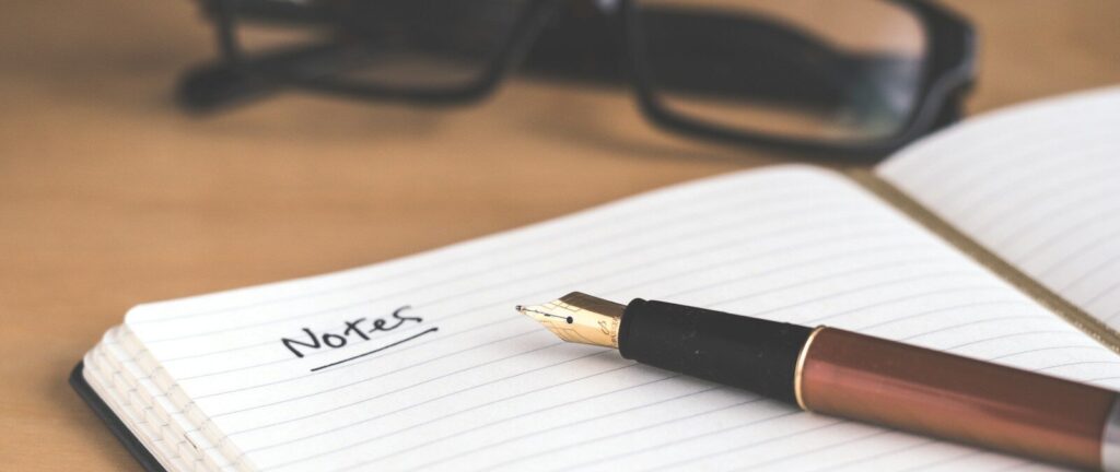 brown fountain pen on notebook