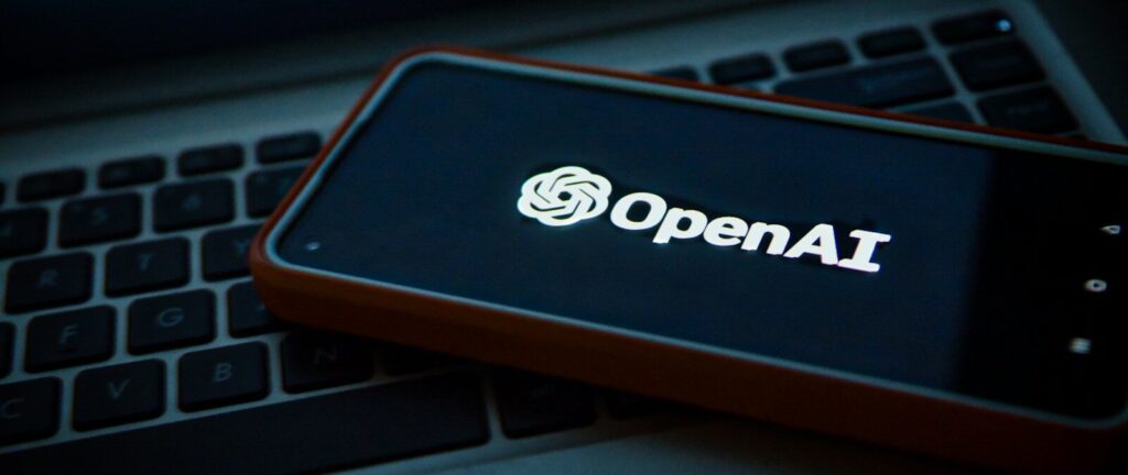 a cell phone sitting on top of a laptop computer