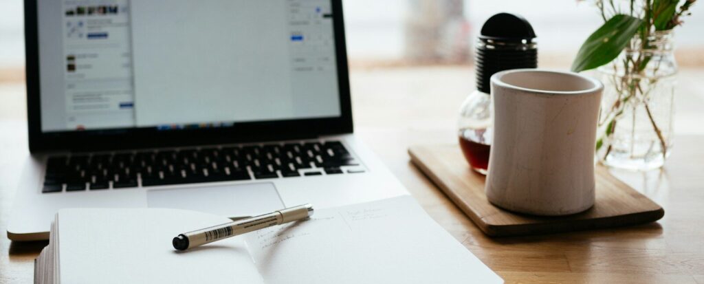 MacBook Pro near white open book